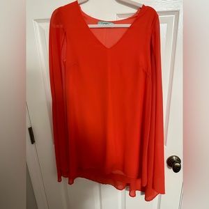 KARLIE orange mini dress with sleeves like a cape.